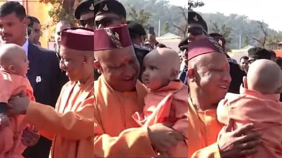 As soon as he reached his village, CM Yogi met 8-month-old Yogi and took him in his lap and showed love to him