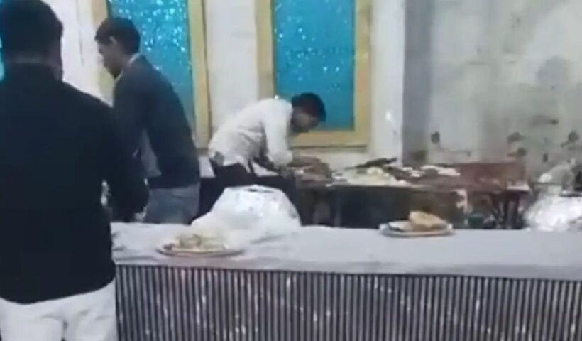 A young man spit on naan at a wedding ceremony