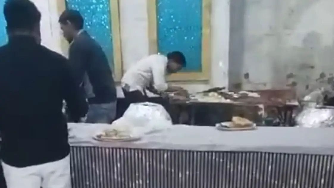 A young man spit on naan at a wedding ceremony